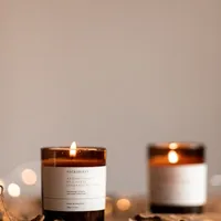 Lit amber glass candles on a table