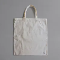 Natural canvas tote bag laid flat